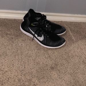 Black and grey Nike running shoes